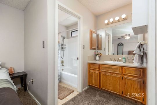 1004 Conejo Avenue Ridgecrest, CA 93555 - Photo 18 of 33 a spacious bathroom with a granite countertop sink mirror and vanity