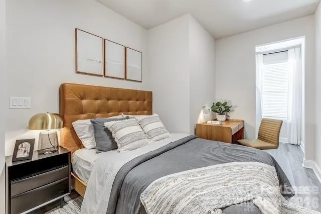 a bedroom with a bed and window