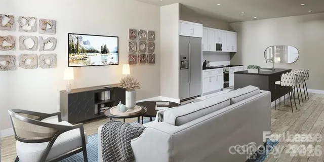 a living room with furniture a refrigerator and kitchen