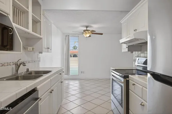a kitchen that has a sink and a stove