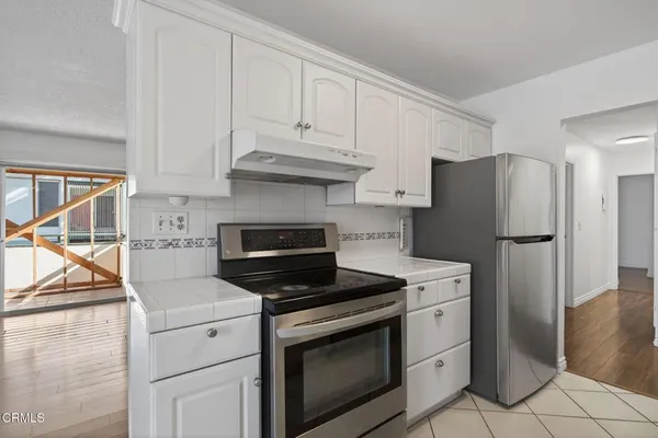a kitchen with cabinets and steel stainless steel appliances