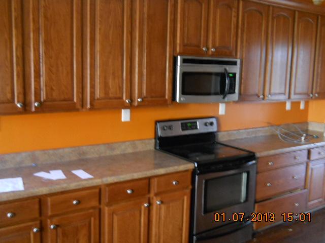675 Sugar Flat Road Lebanon, TN 37087 - Photo 20 of 20 a utility room with stainless steel appliances wooden cabinets and a stove top oven