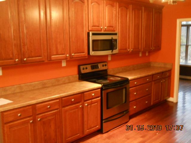 675 Sugar Flat Road Lebanon, TN 37087 - Photo 4 of 20 a kitchen with stainless steel appliances wooden cabinets and a stove top oven