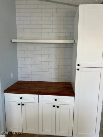 a view of a room with a ceiling fan and a window