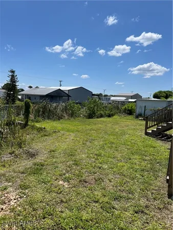 a view of a garden with a building in the background