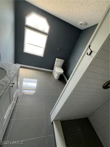 a kitchen with stainless steel appliances granite countertop a stove and a wooden floors
