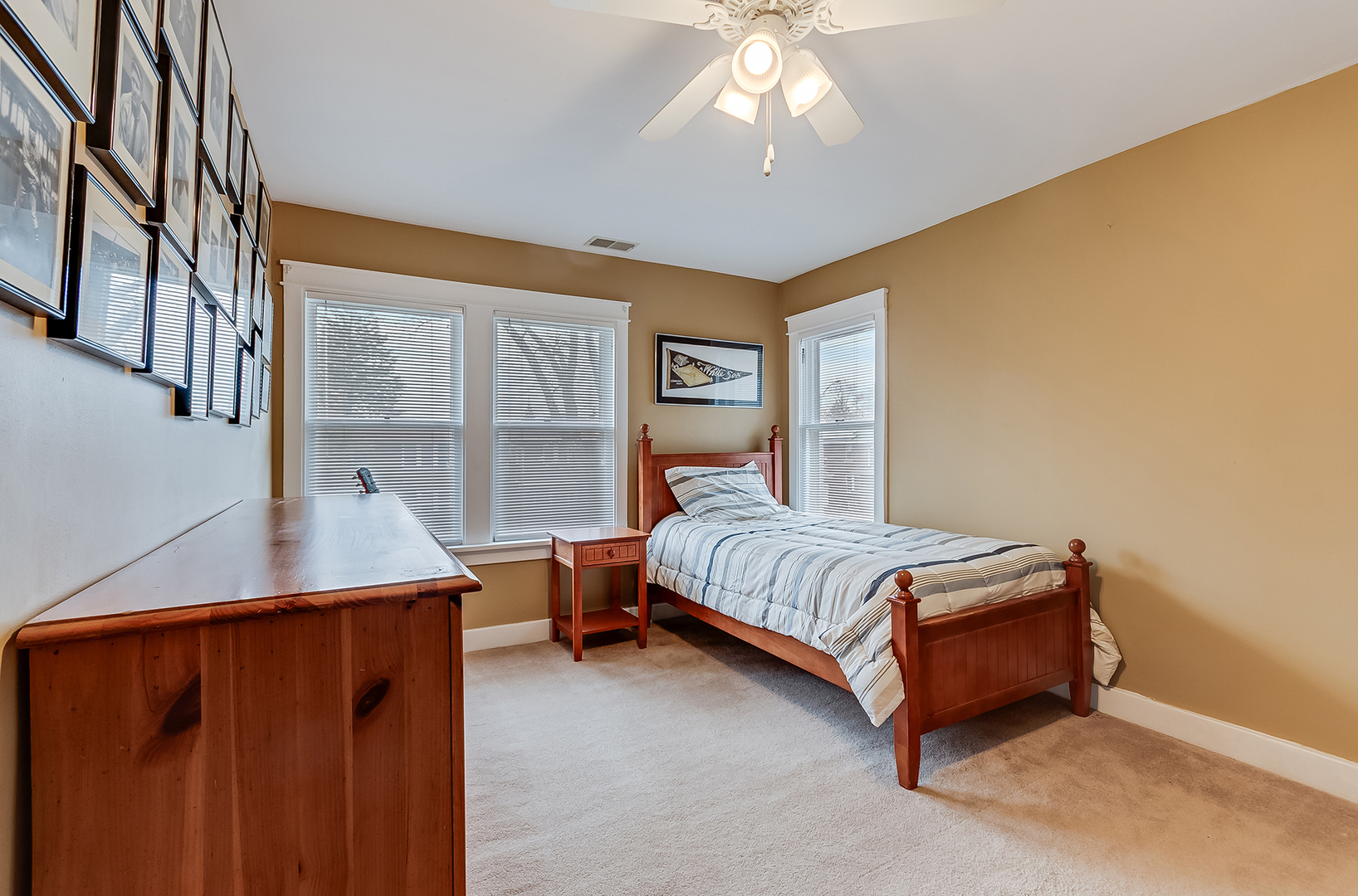 409 Cornelia Street Joliet, IL 60435 - Photo 14 of 27 a bedroom with a bed and a chandelier