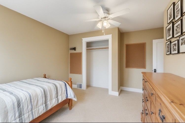 409 Cornelia Street Joliet, IL 60435 - Photo 15 of 27 a bedroom with a bed and a chandelier