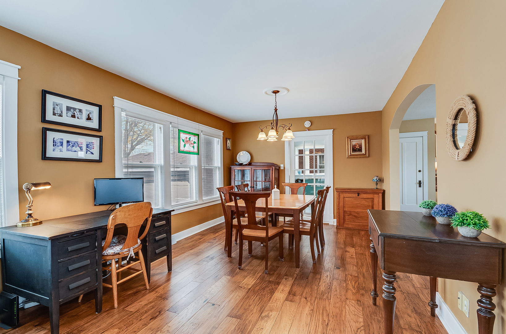 409 Cornelia Street Joliet, IL 60435 - Photo 6 of 27 a dining room with furniture a chandelier and wooden floor
