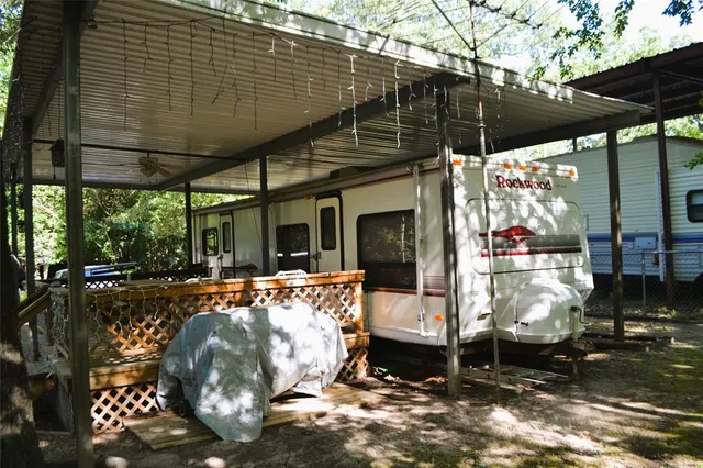 a view of a chairs and table in backyard