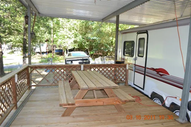 a view of a chairs and table in patio with wooden floor
