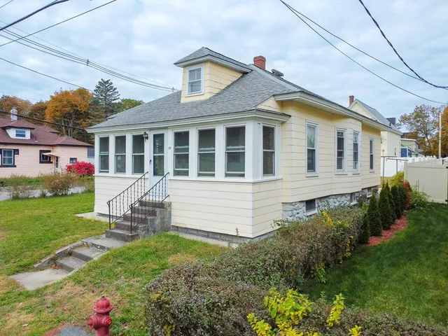 a front view of a house with a garden and plants