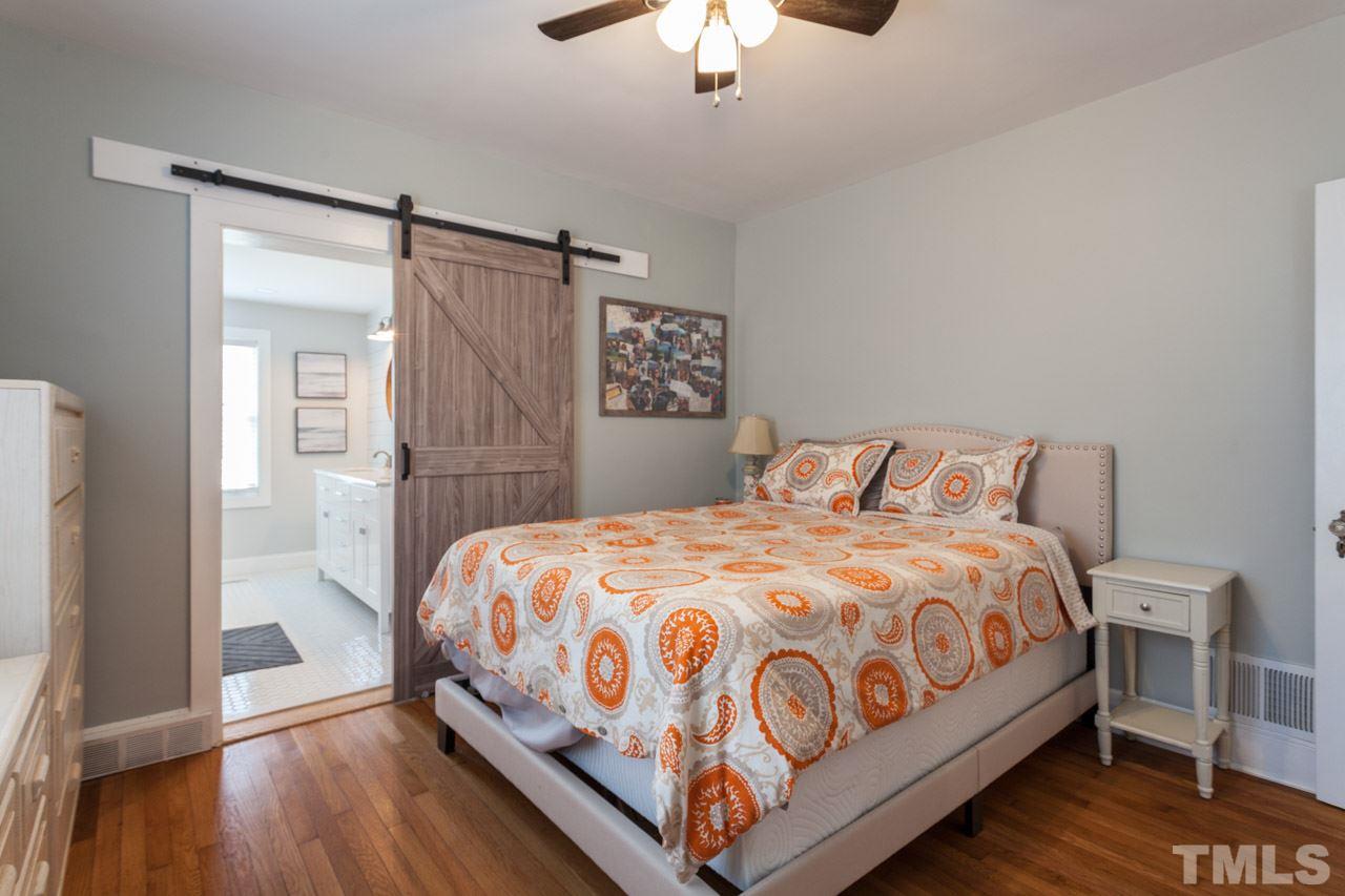 605 Dixie Trail Raleigh, NC 27607 - Photo 14 of 20 a bedroom with a bed and a chandelier