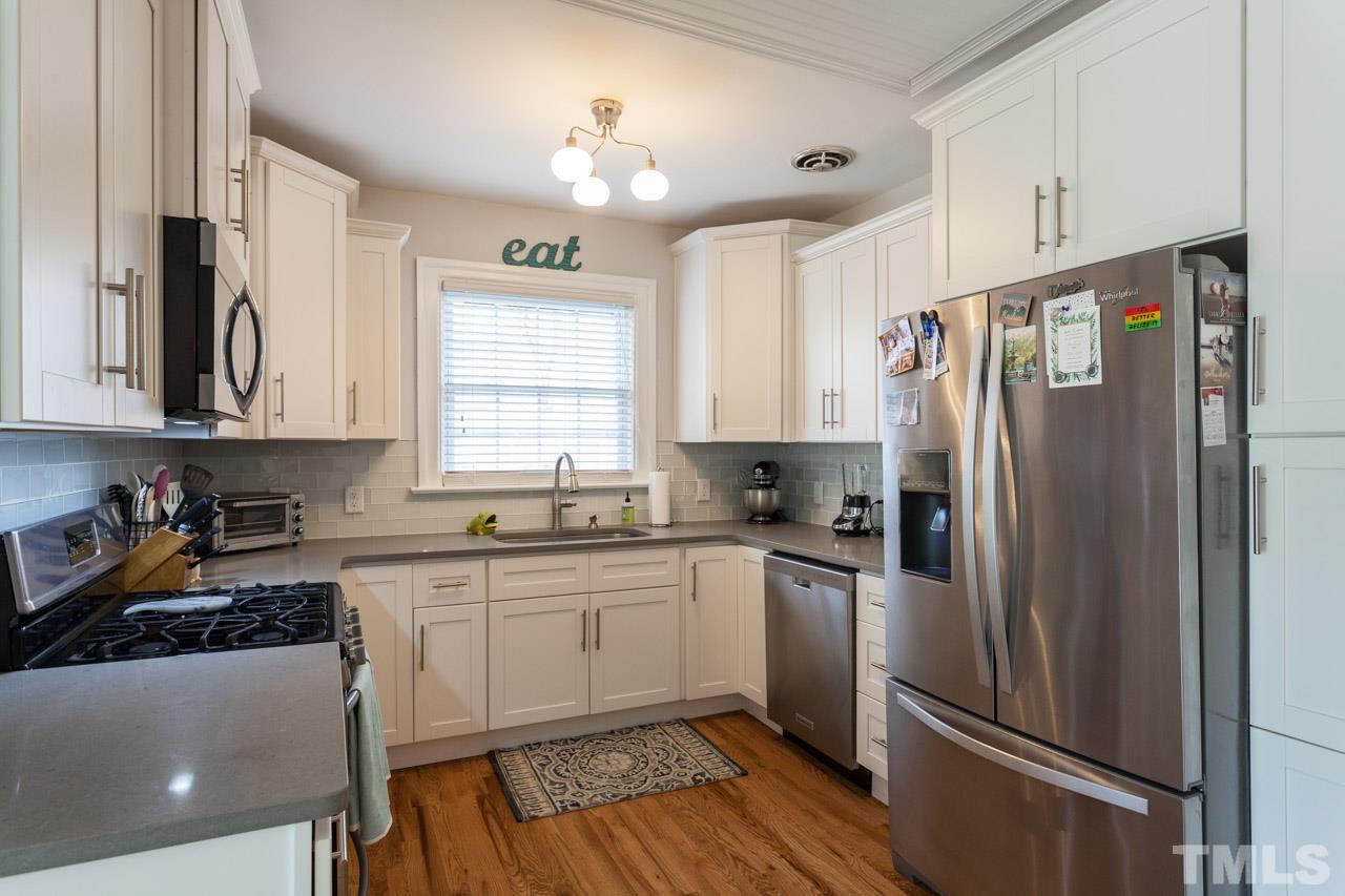 605 Dixie Trail Raleigh, NC 27607 - Photo 8 of 20 a kitchen with stainless steel appliances a refrigerator sink and cabinets