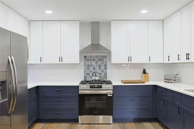 a kitchen with stainless steel appliances granite countertop a stove and a refrigerator
