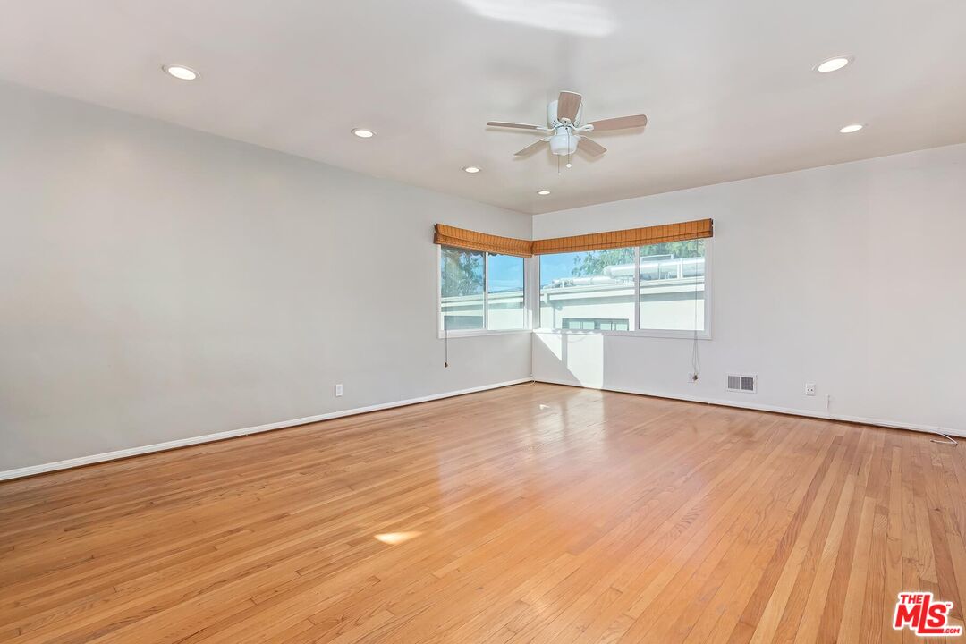 2106 Rockford Road Los Angeles, CA 90039 - Photo 25 of 66 an empty room with wooden floor fan and windows
