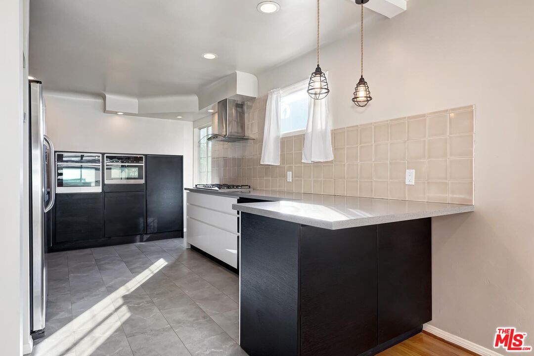 2106 Rockford Road Los Angeles, CA 90039 - Photo 30 of 66 a kitchen with stainless steel appliances granite countertop a sink a counter space and cabinets