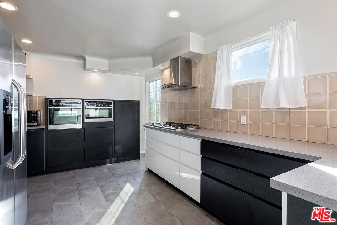 2106 Rockford Road Los Angeles, CA 90039 - Photo 31 of 66 a kitchen with stainless steel appliances a sink stove and refrigerator
