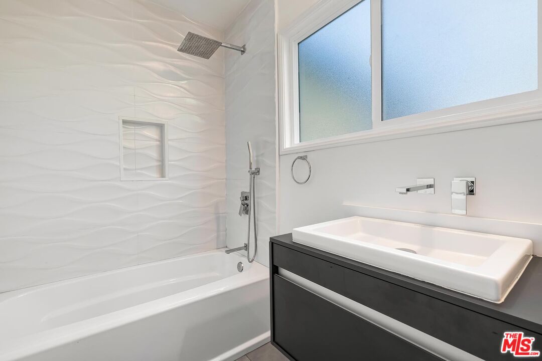 2106 Rockford Road Los Angeles, CA 90039 - Photo 39 of 66 a bathroom with a sink a bathtub and a shower