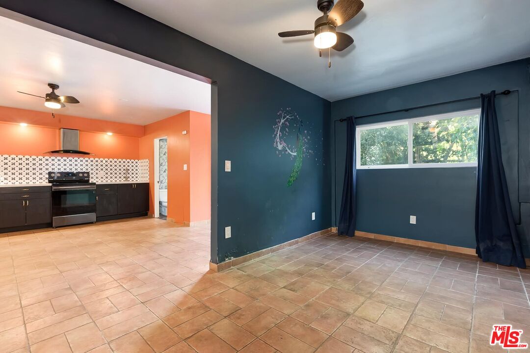 2106 Rockford Road Los Angeles, CA 90039 - Photo 45 of 66 a view of an empty room with a fireplace and a ceiling fan