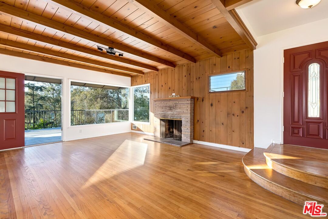 2106 Rockford Road Los Angeles, CA 90039 - Photo 48 of 66 a view of empty room with wooden floor and fireplace