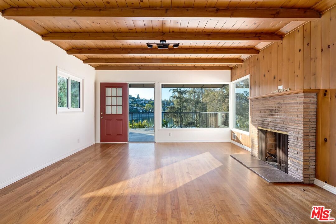 2106 Rockford Road Los Angeles, CA 90039 - Photo 49 of 66 a view of an empty room with wooden floor fireplace and a window