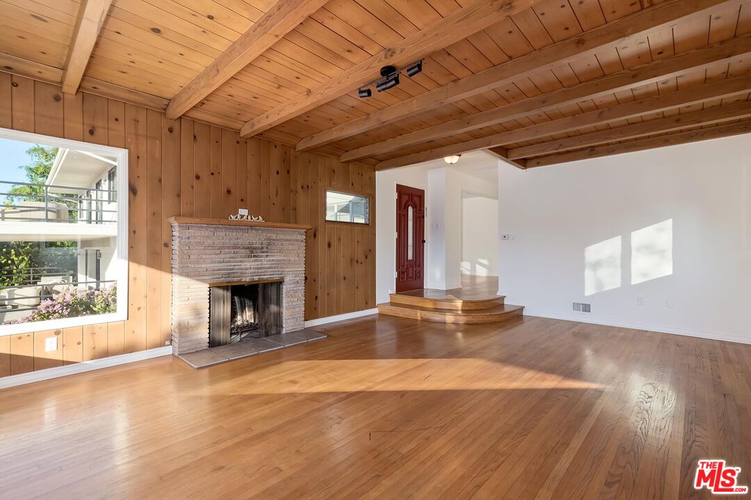 2106 Rockford Road Los Angeles, CA 90039 - Photo 51 of 66 a view of an empty room with wooden floor and a fireplace