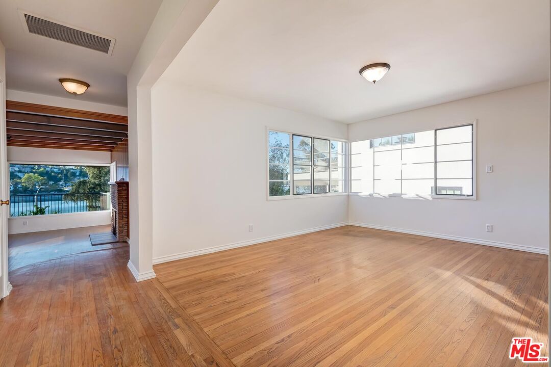 2106 Rockford Road Los Angeles, CA 90039 - Photo 53 of 66 an empty room with wooden floor and windows