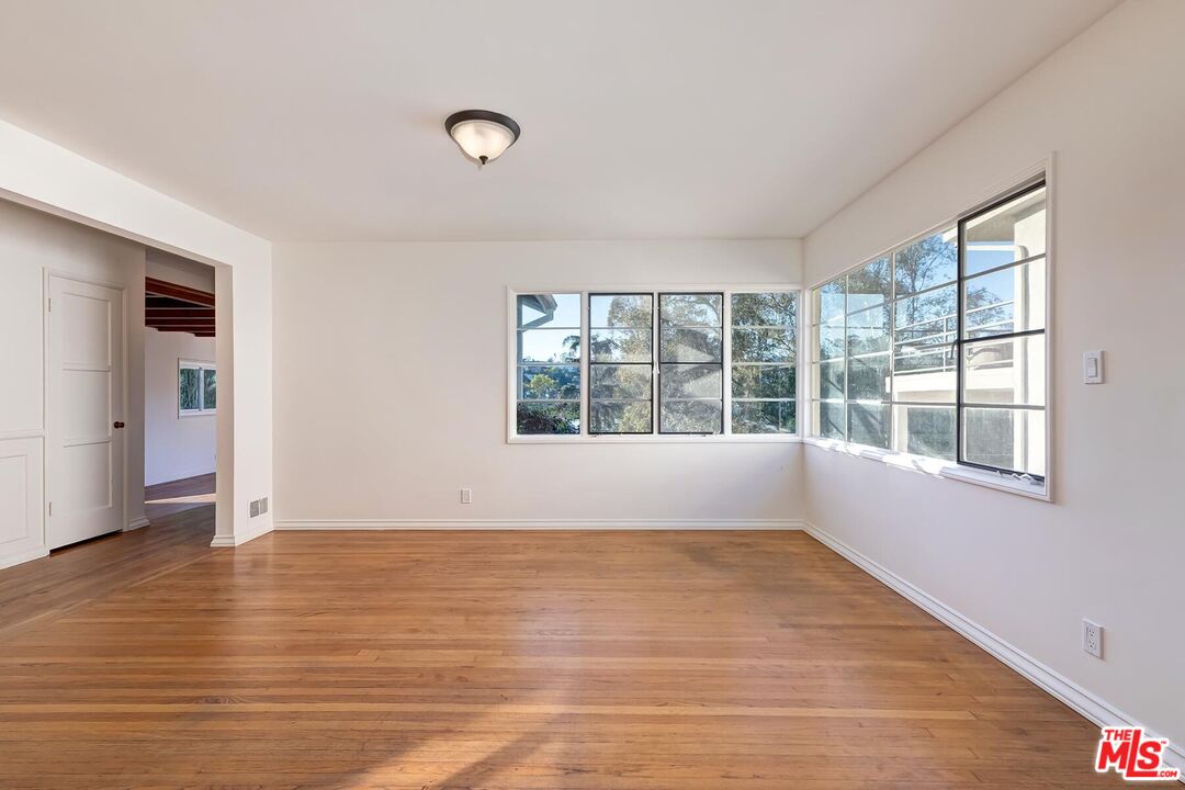 2106 Rockford Road Los Angeles, CA 90039 - Photo 55 of 66 a view of an empty room with wooden floor and a window
