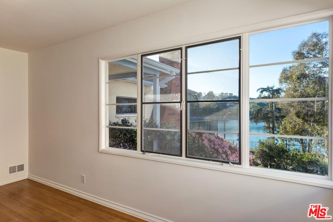 2106 Rockford Road Los Angeles, CA 90039 - Photo 56 of 66 an empty room with wooden floor and a window