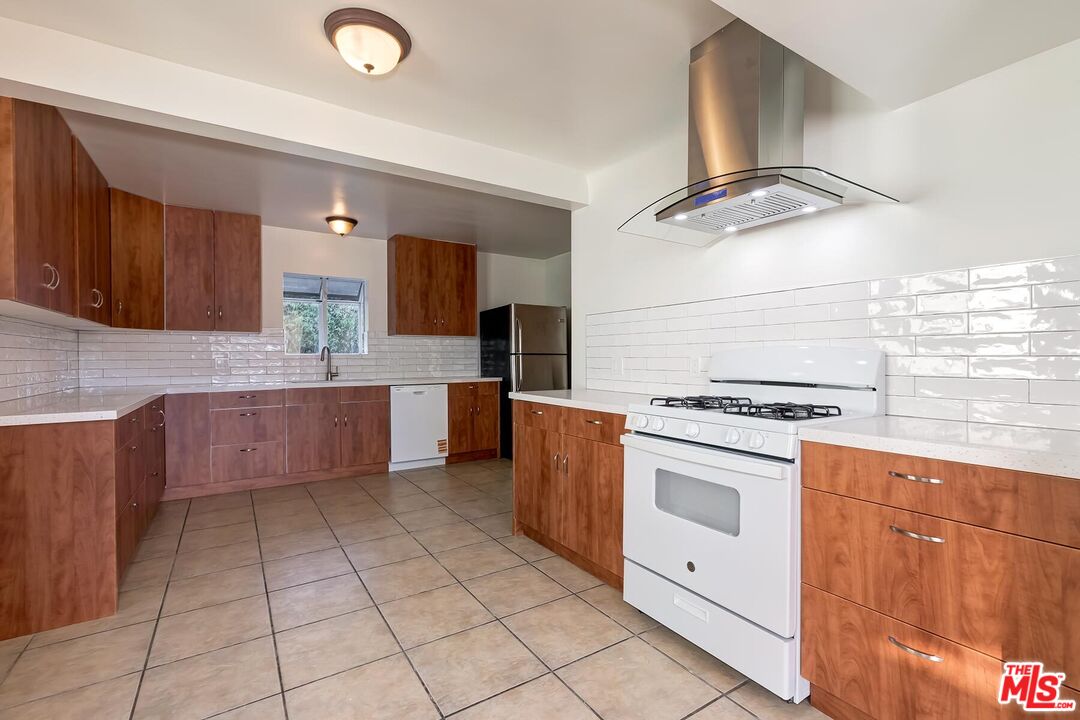 2106 Rockford Road Los Angeles, CA 90039 - Photo 59 of 66 a kitchen with cabinets and white appliances