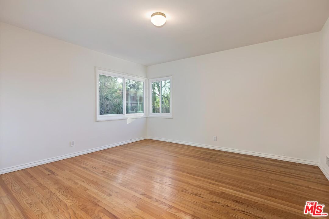 2106 Rockford Road Los Angeles, CA 90039 - Photo 63 of 66 an empty room with wooden floor and windows