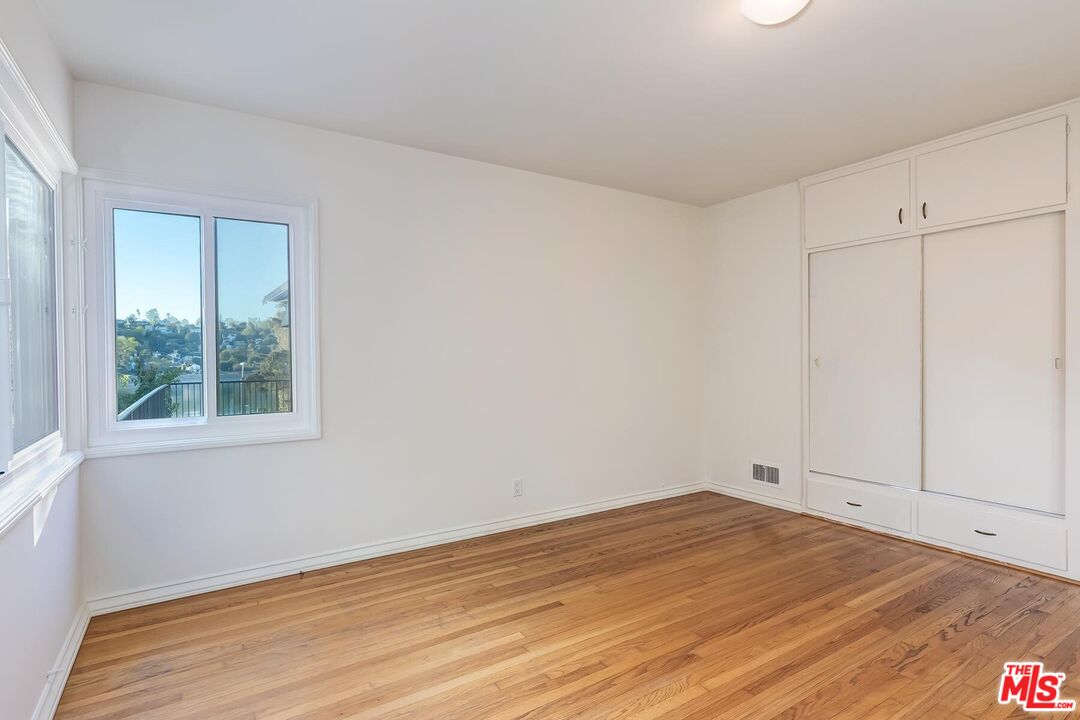 2106 Rockford Road Los Angeles, CA 90039 - Photo 64 of 66 a view of empty room with wooden floor and fan