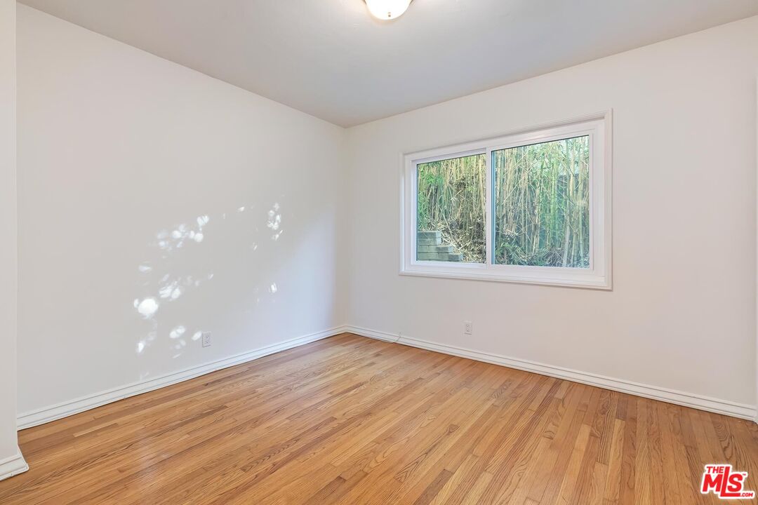 2106 Rockford Road Los Angeles, CA 90039 - Photo 65 of 66 a view of an empty room with wooden floor and a window