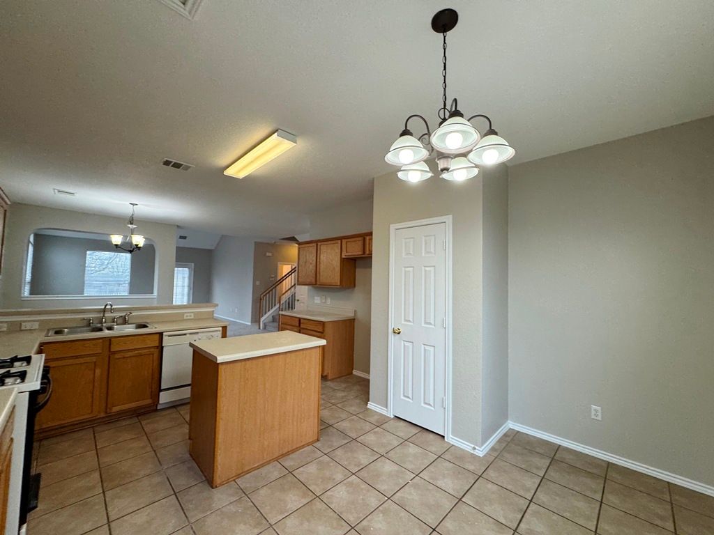 544 Hogan Kyle, TX 78640 - Photo 11 of 40 a kitchen that has a lot of cabinets in it