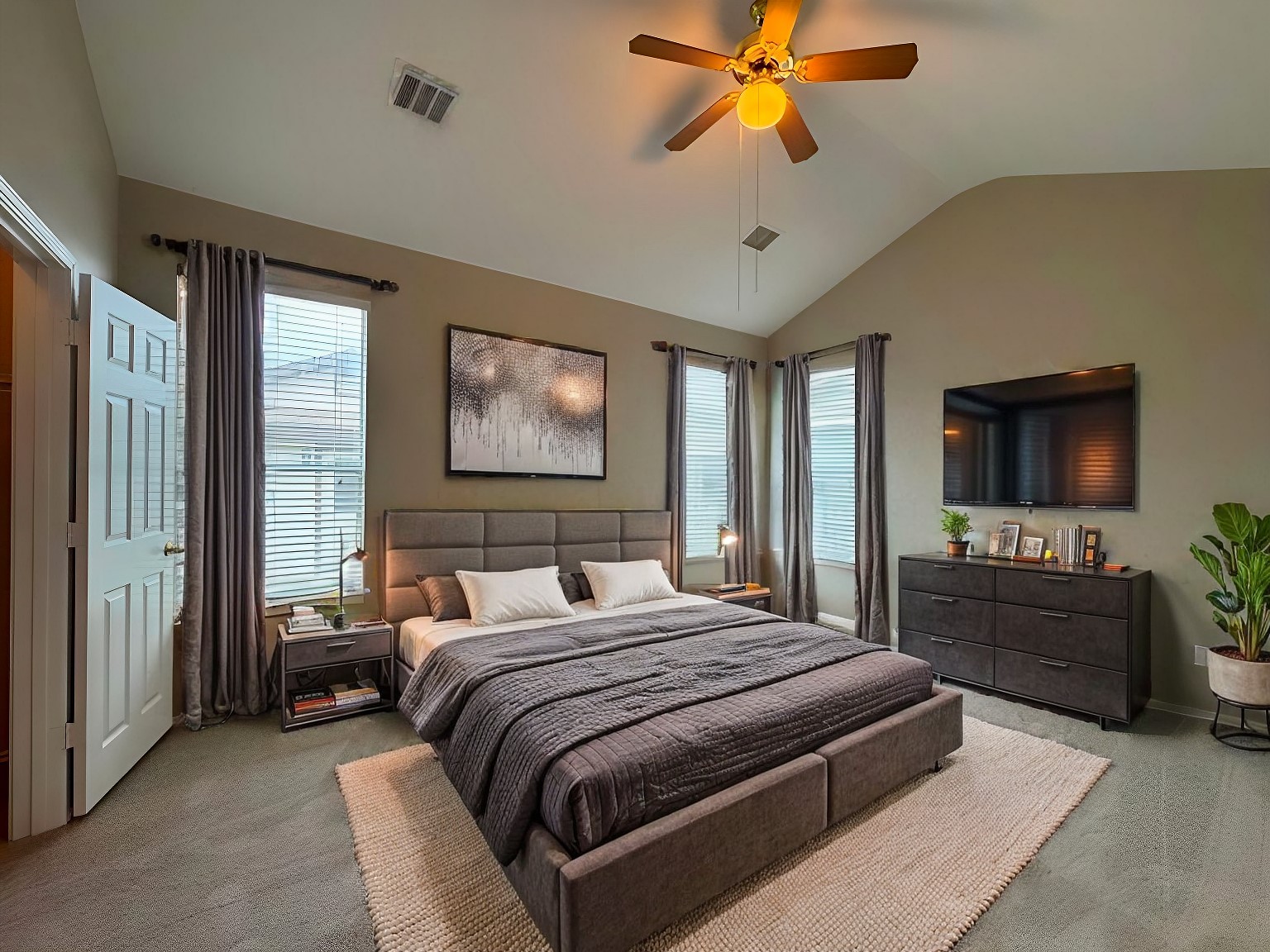 544 Hogan Kyle, TX 78640 - Photo 20 of 40 a bedroom with a bed a dresser and a flat screen tv