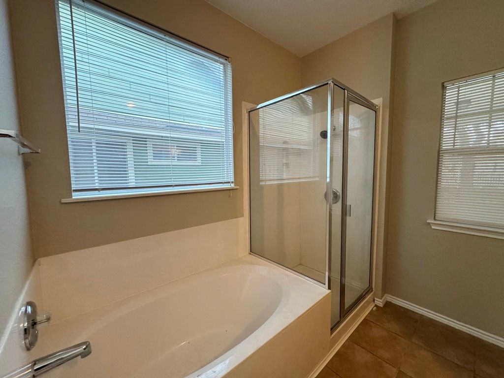 544 Hogan Kyle, TX 78640 - Photo 25 of 40 a bathroom with a tub and shower