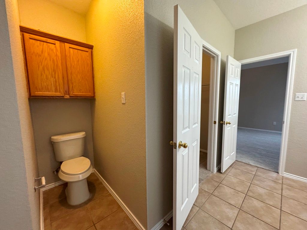 544 Hogan Kyle, TX 78640 - Photo 26 of 40 a bathroom with a granite countertop toilet and a sink