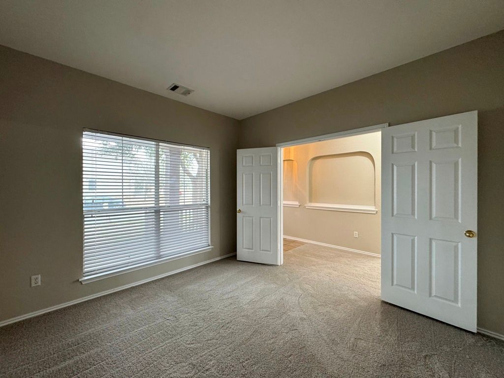 544 Hogan Kyle, TX 78640 - Photo 4 of 40 an empty room with windows