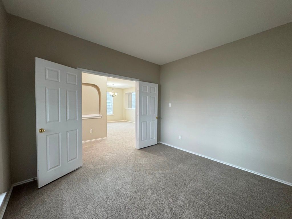 544 Hogan Kyle, TX 78640 - Photo 5 of 40 a view of an empty room with glass door