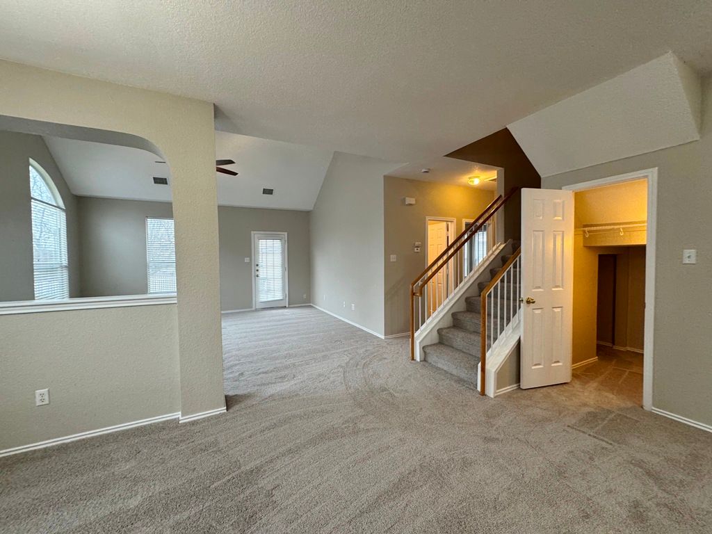 544 Hogan Kyle, TX 78640 - Photo 8 of 40 a view of an empty room with a fireplace and a window