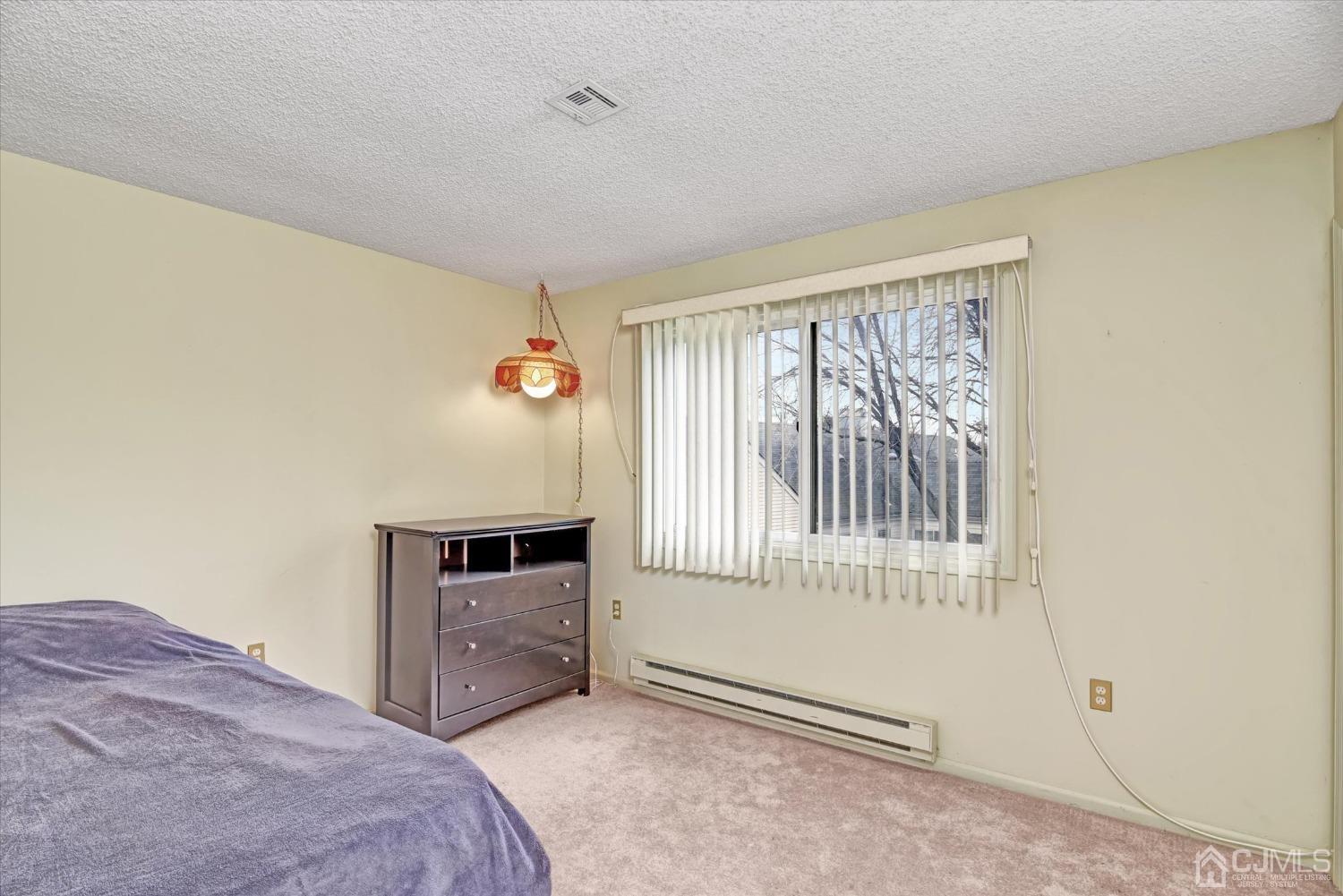 569 Old Nassau Road, Unit O Iselin, NJ 08830 - Photo 13 of 38 a bedroom with a bed and a window
