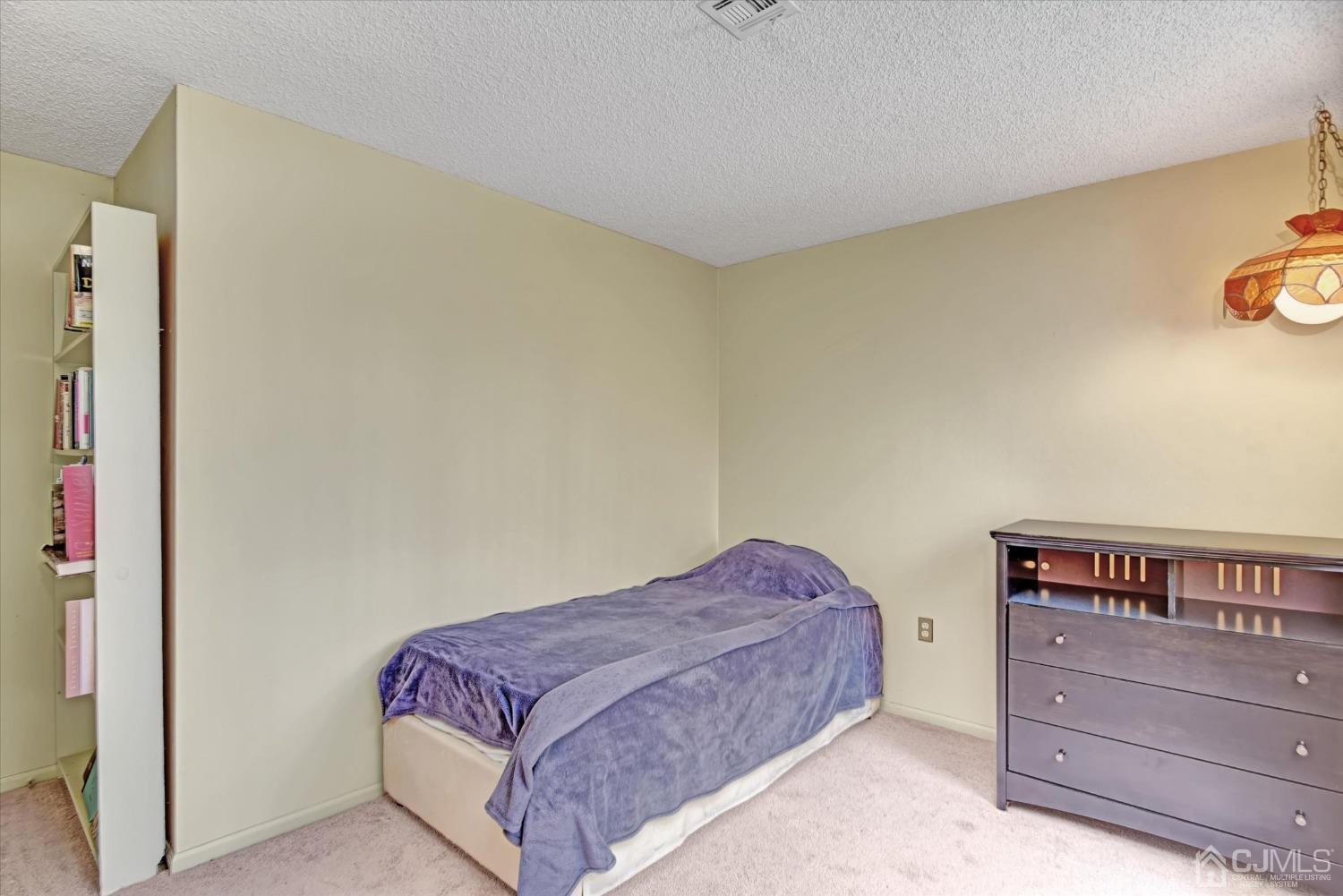 569 Old Nassau Road, Unit O Iselin, NJ 08830 - Photo 14 of 38 a bedroom with a bed and a dresser
