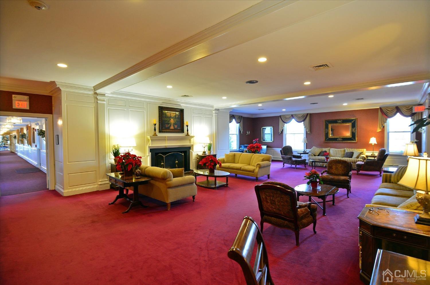 569 Old Nassau Road, Unit O Iselin, NJ 08830 - Photo 25 of 38 a living room with furniture a fireplace and a flat screen tv