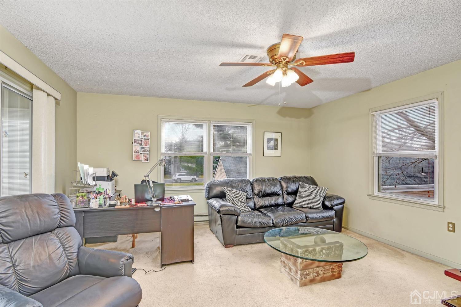 569 Old Nassau Road, Unit O Iselin, NJ 08830 - Photo 4 of 38 a living room with furniture a table and a large window
