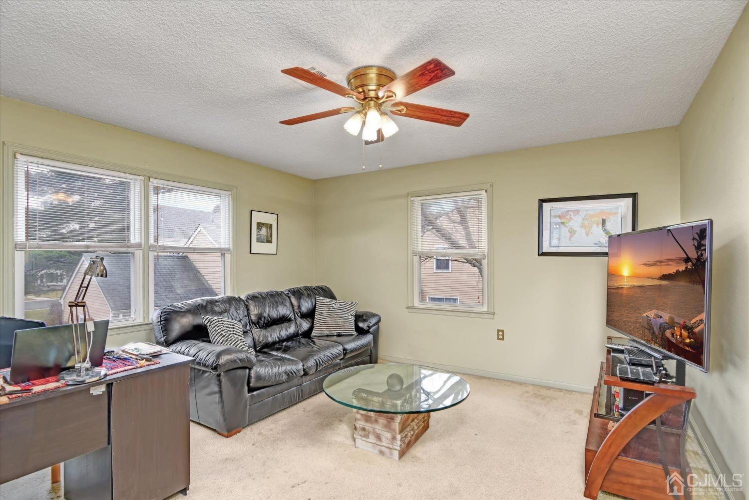 569 Old Nassau Road, Unit O Iselin, NJ 08830 - Photo 5 of 38 a living room with furniture a table and a window