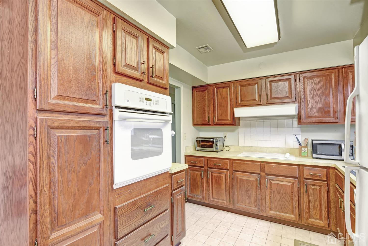 569 Old Nassau Road, Unit O Iselin, NJ 08830 - Photo 8 of 38 a kitchen with stainless steel appliances granite countertop a refrigerator and cabinets
