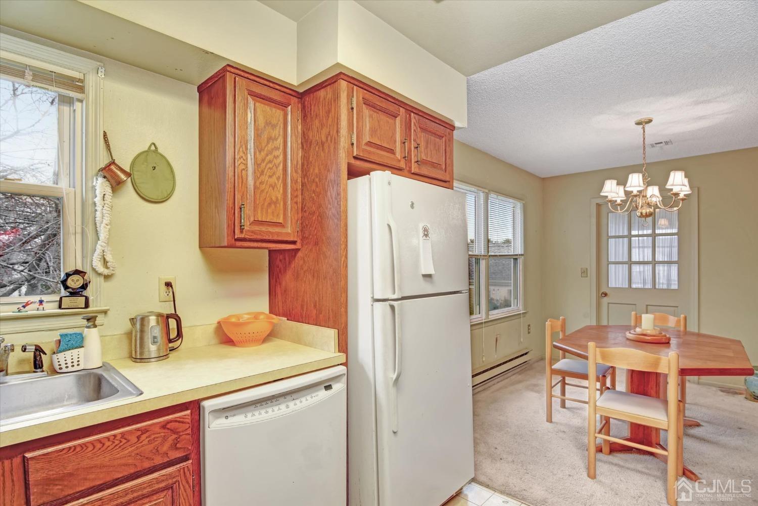 569 Old Nassau Road, Unit O Iselin, NJ 08830 - Photo 10 of 38 a kitchen with dining table and appliances