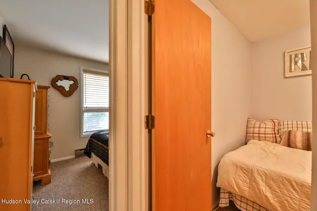 a bedroom with a bed next to a window