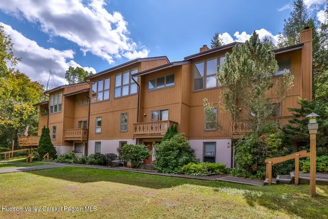 a front view of a residential apartment building with a yard